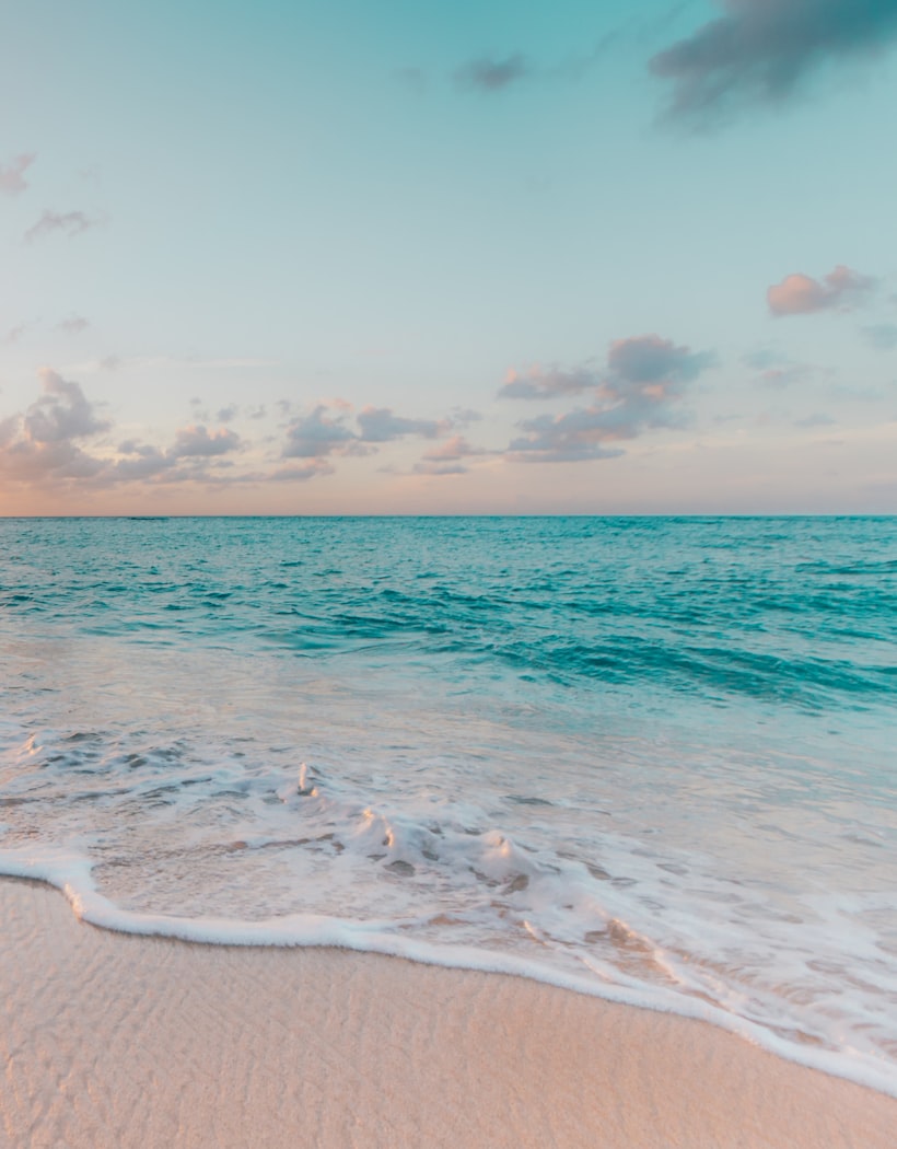 A turquoise beach at sunset — your first memory